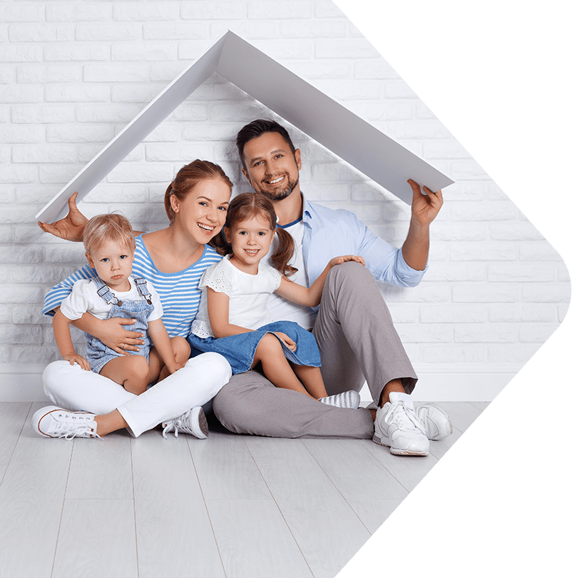 Image showing a family of 4 sitting on the floor under a roof made of cardboard