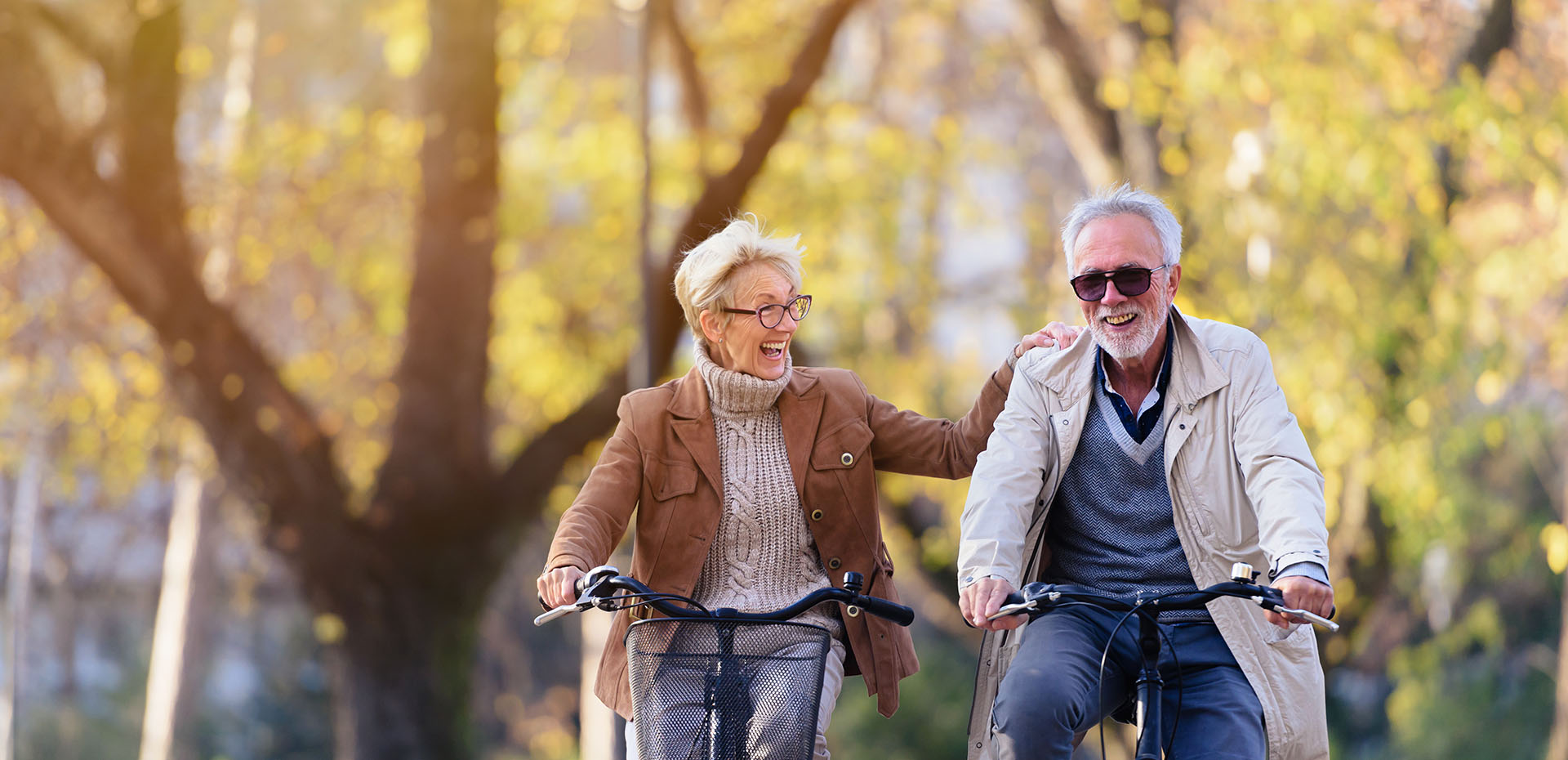 Image showing a happy older couple on bikes