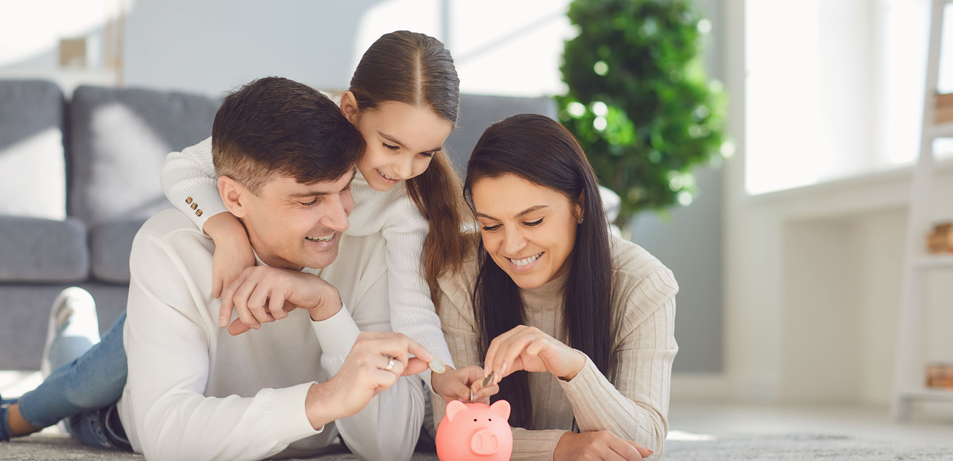 Image showing a family putting money in a piggy bank together