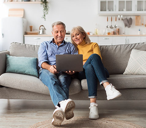 Image showing an older couple looking at their laptop together