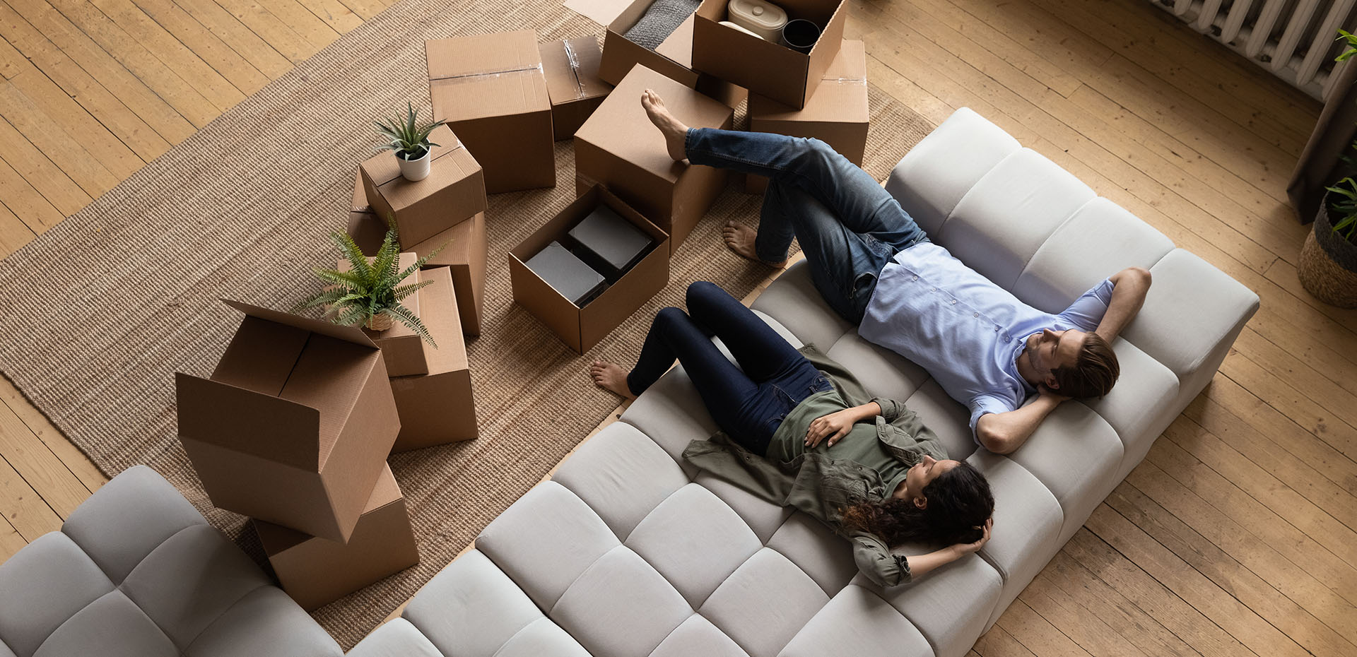 Image showing a couple sitting on the couch surrounded by boxes