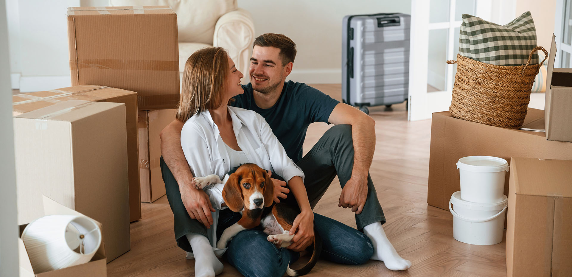 Image showing a couple with their dog surrounded by boxes