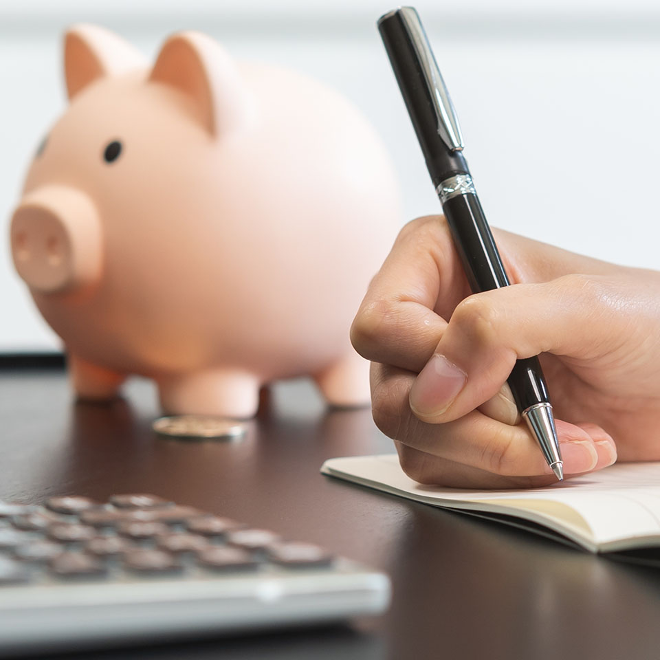 Image showing a close up of a piggy bank and a calculator