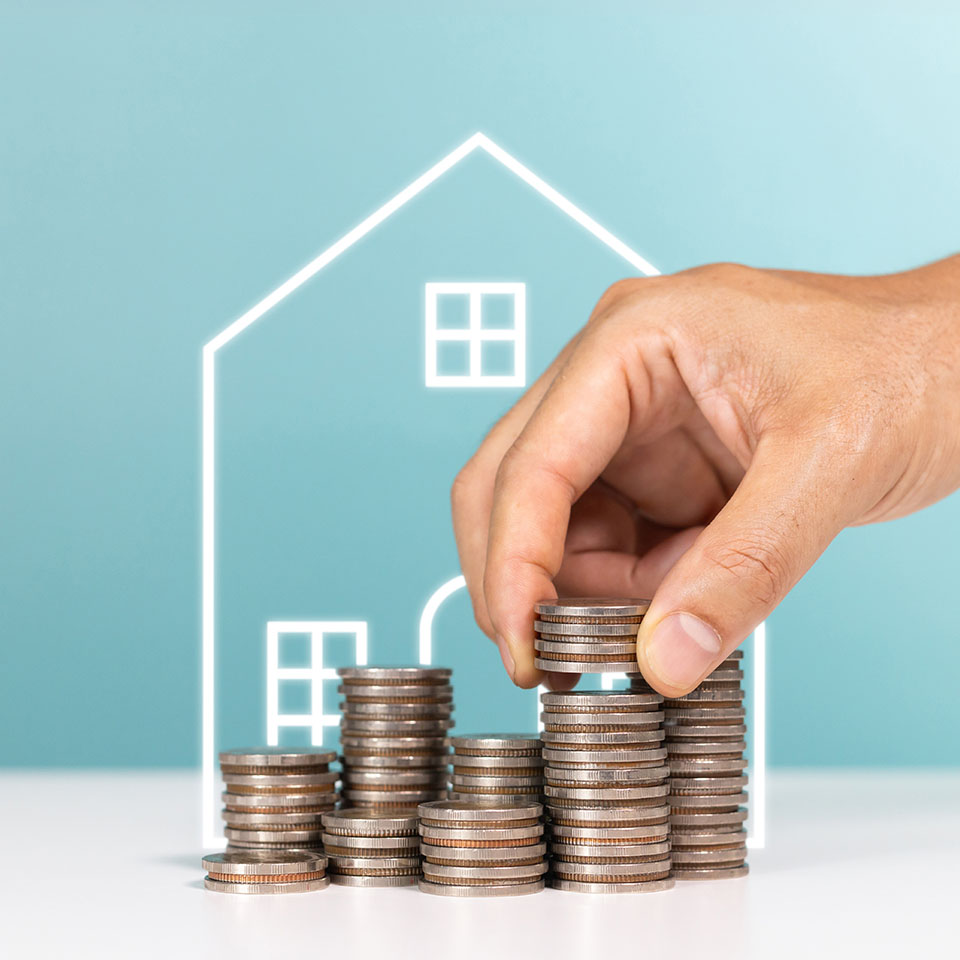 Image showing piles of coins in front of a drawing of a house