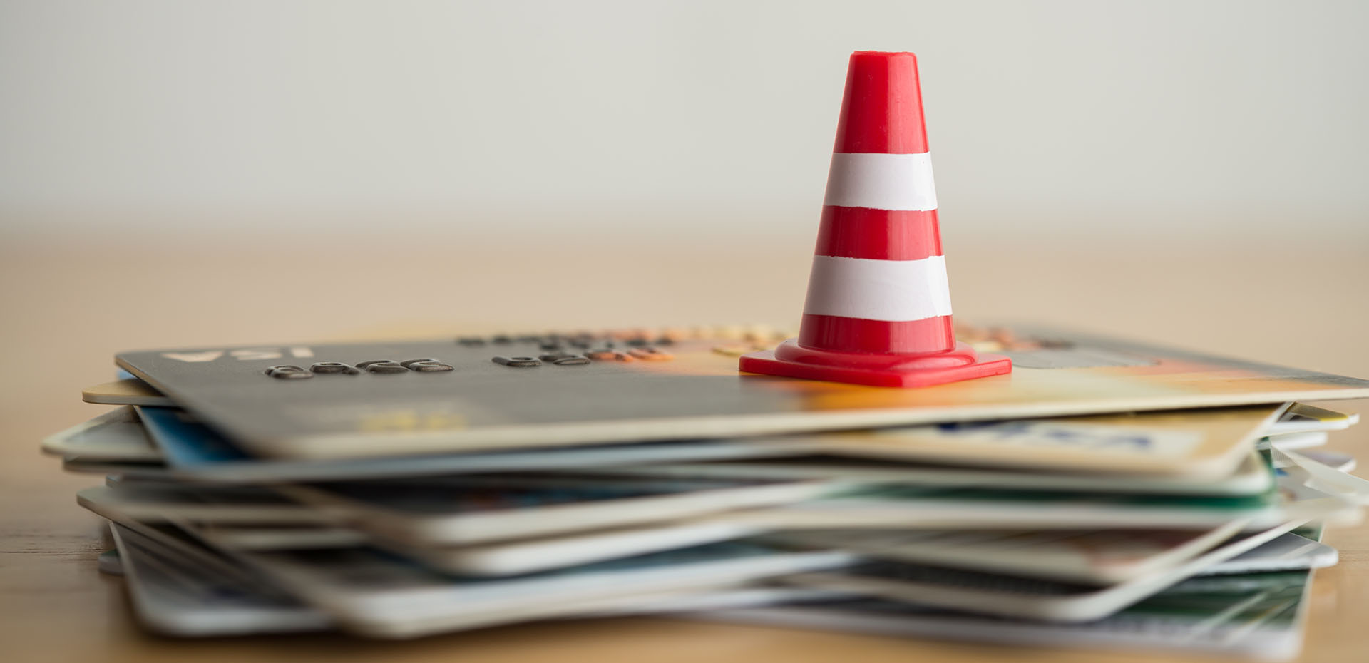 Image showing a warning cone on top of a pile of credit cards