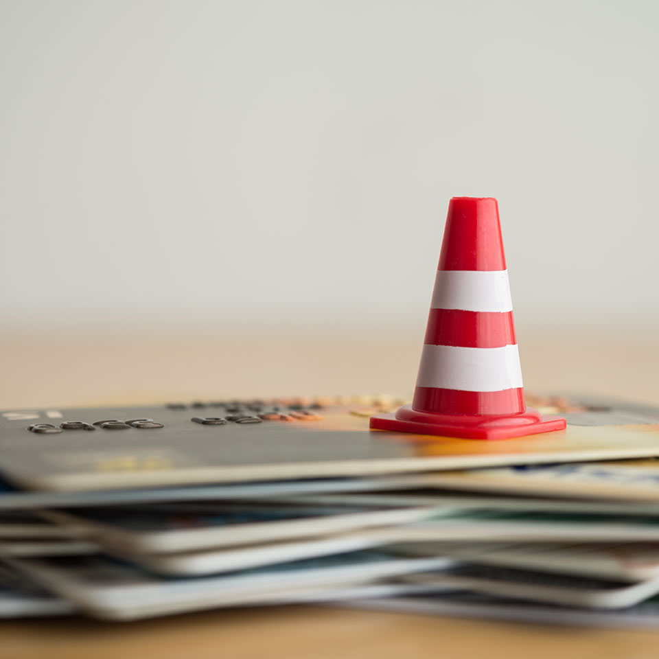 Image showing a warning cone on top of a pile of credit cards