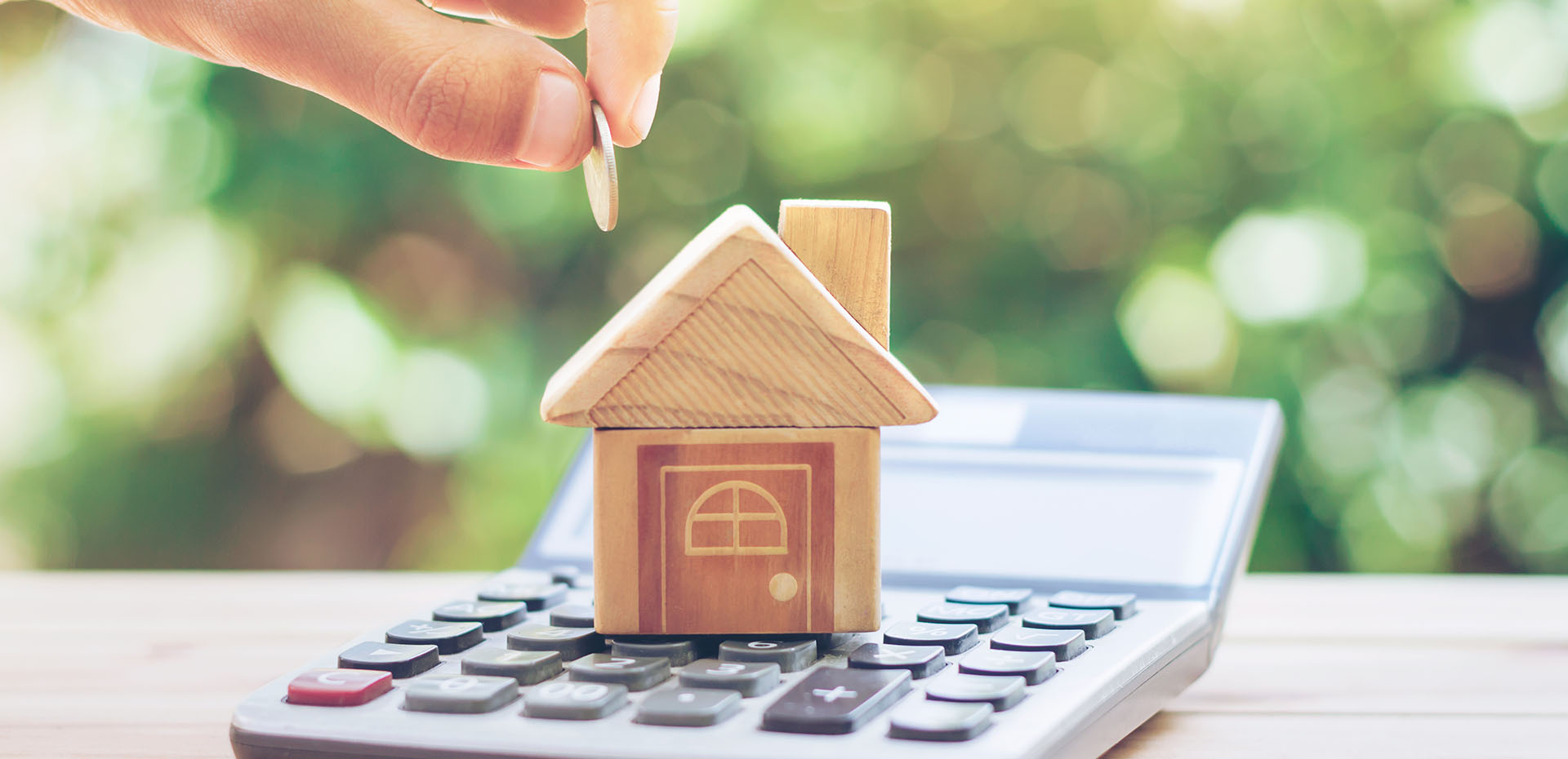 Image showing a model house on top of a calculator