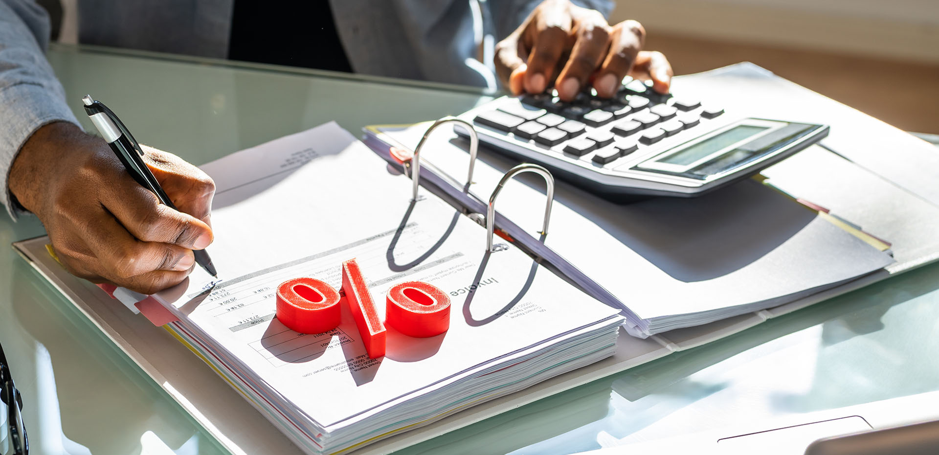 Image showing a close up of a broker using a calculator