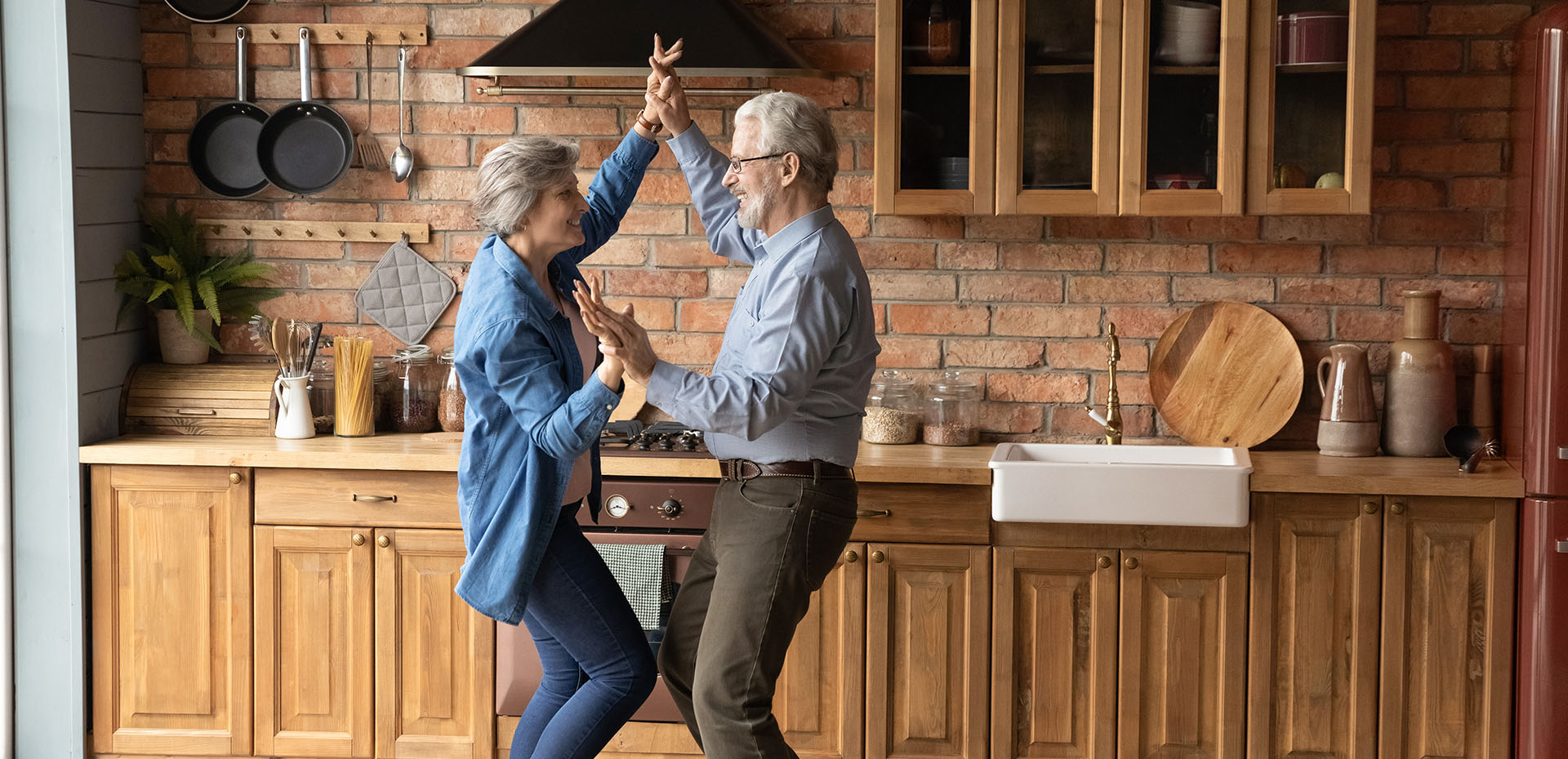 Image showing an older couple dancing in their kitchen