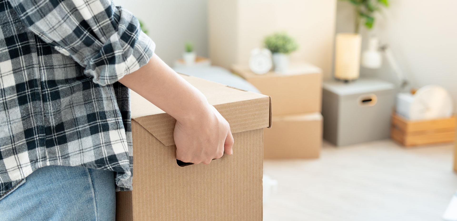 Image showing a close up of a woman carrying a box