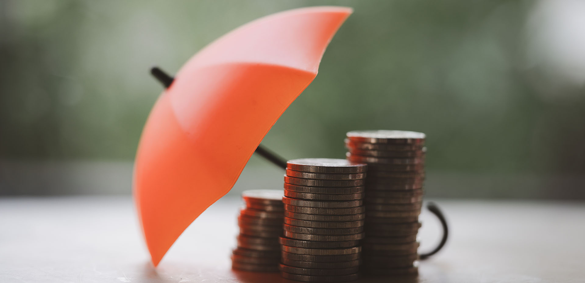 Image showing an umbrella covering piles of coins