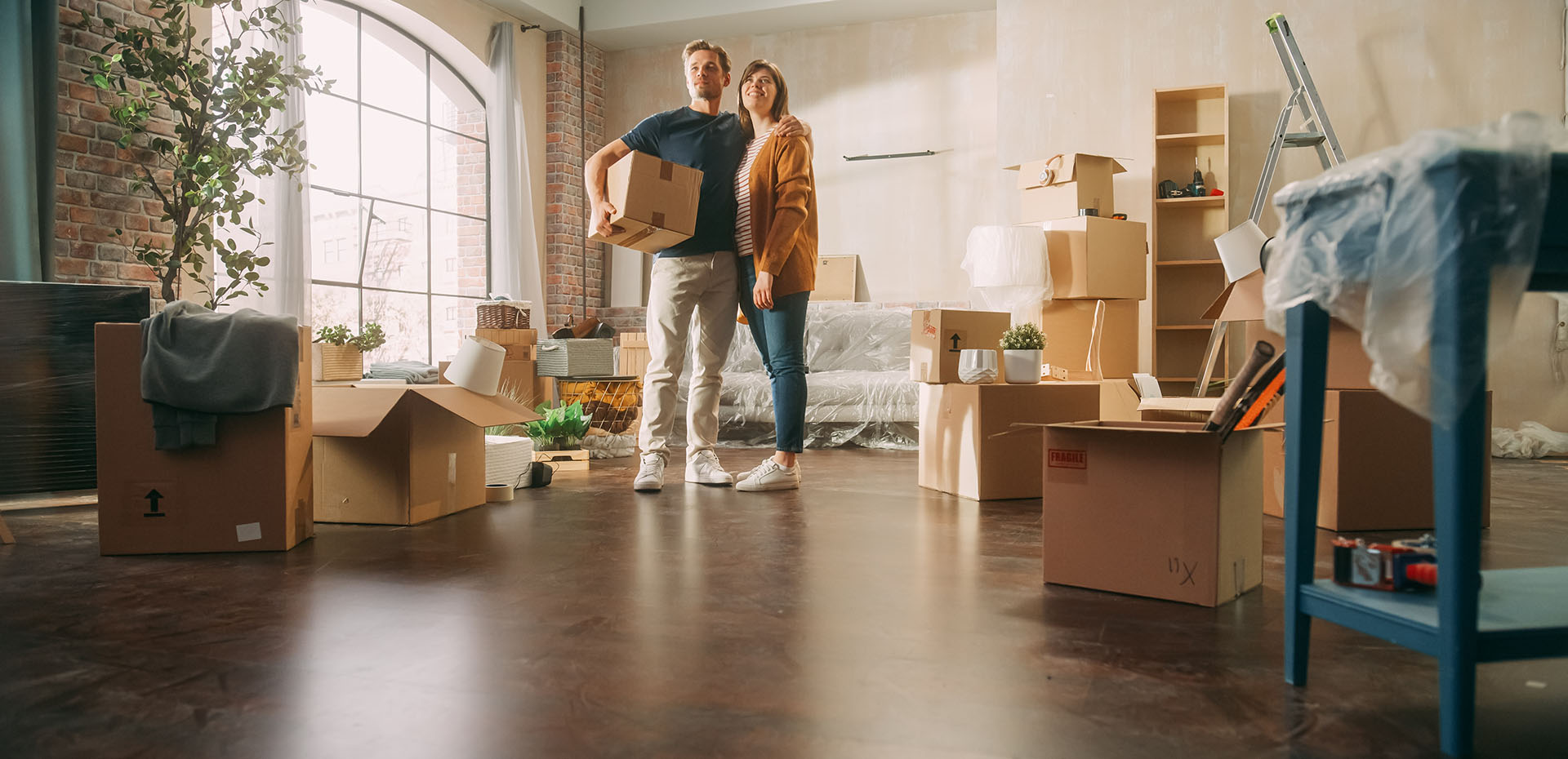 Image showing a couple surrounded by moving boxes