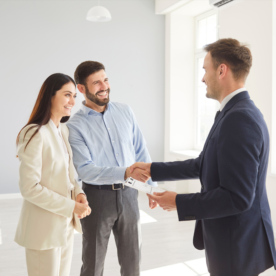 Couple shaking hand with agent