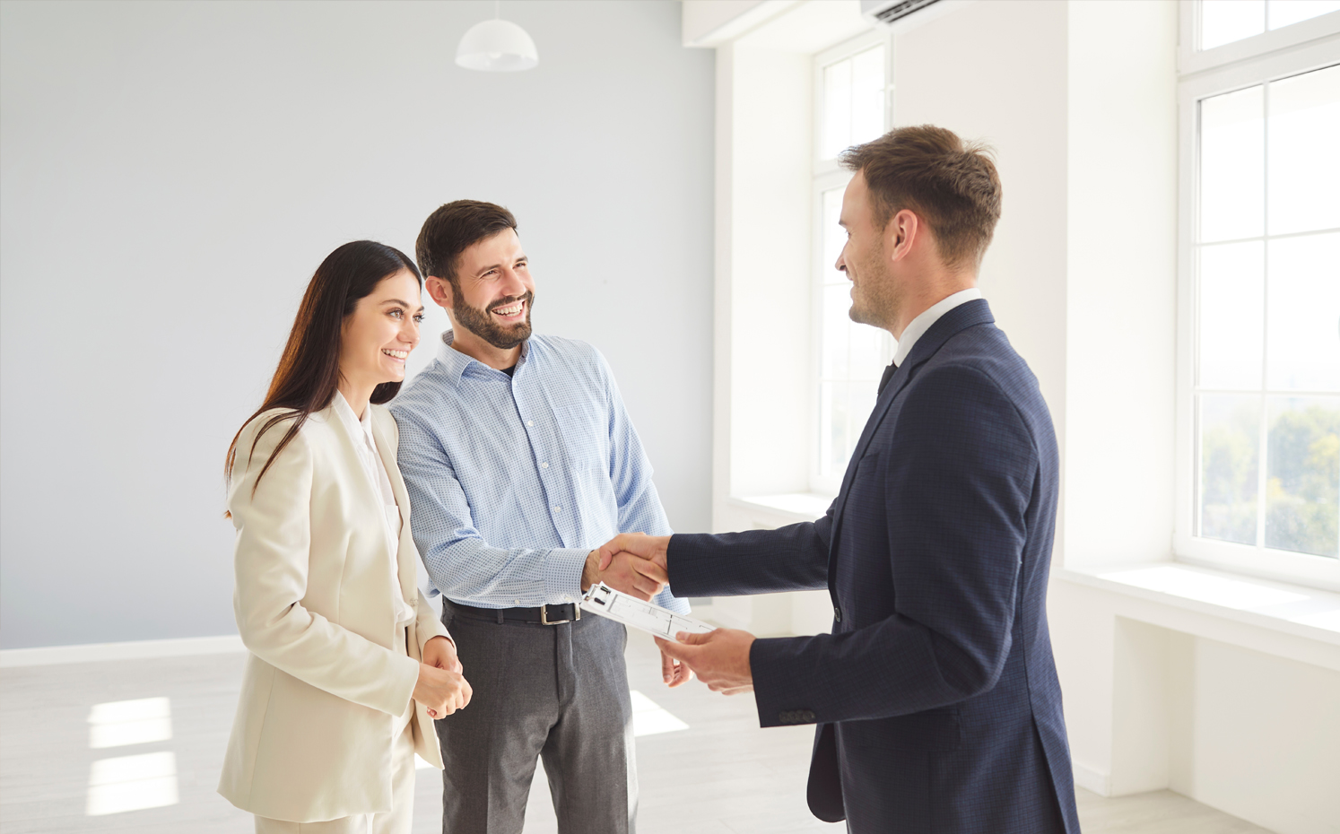 Couple shaking hand with agent