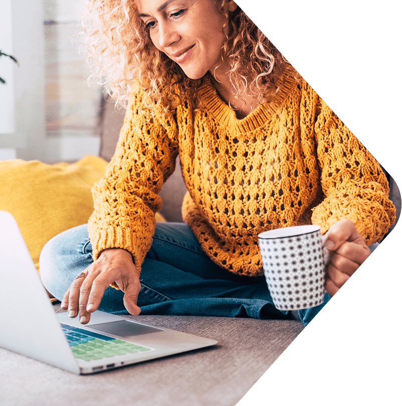 Image showing a woman sitting on her couch using her laptop