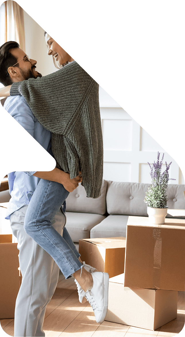 Image showing a happy couple in their new home surrounded by boxes