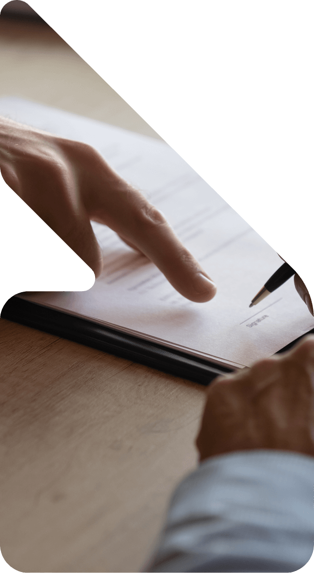 image showing a man signing documents