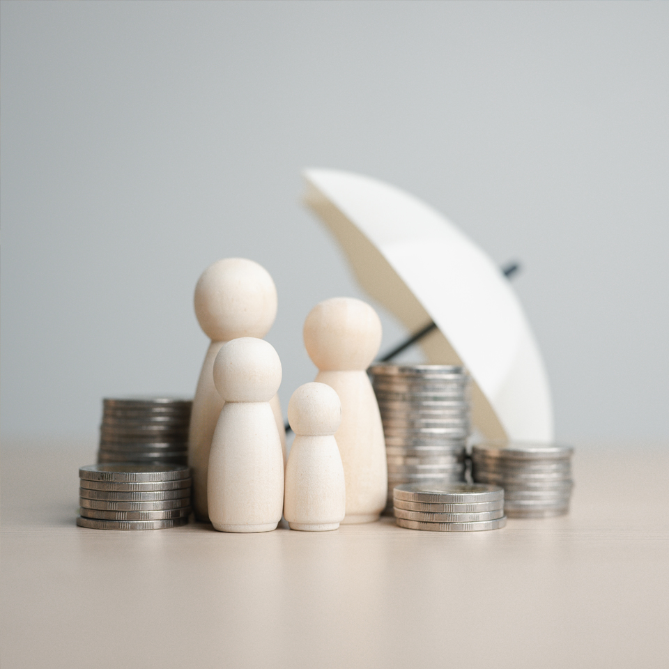 image showing wooden family protected by an umbrella with coins on the side