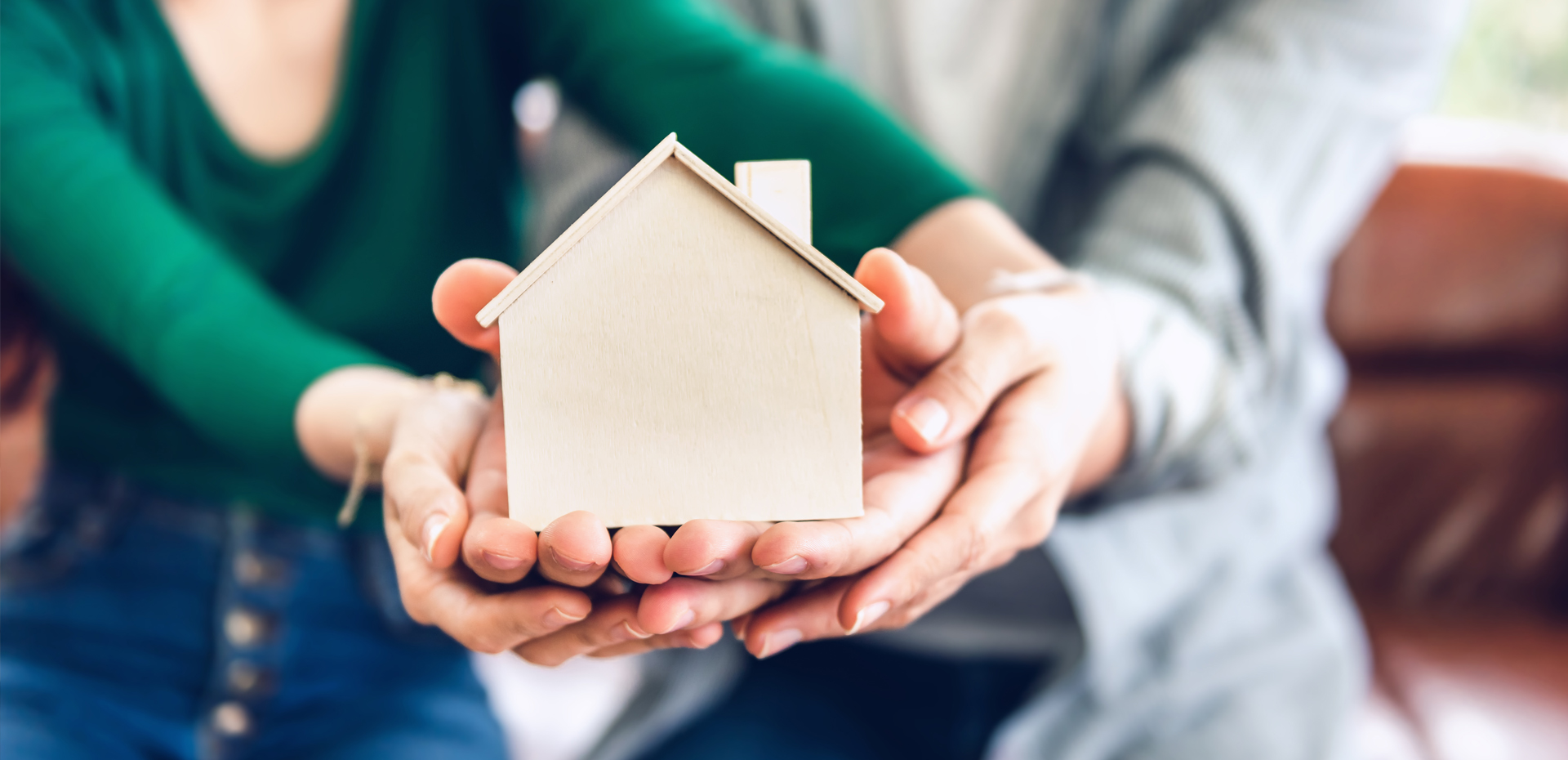 Couple Hands Holding Housing Model