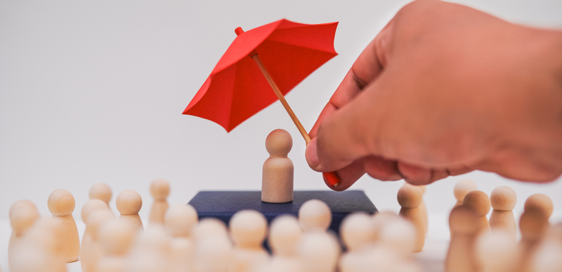 A man holding a umbrella protects the leader and their team