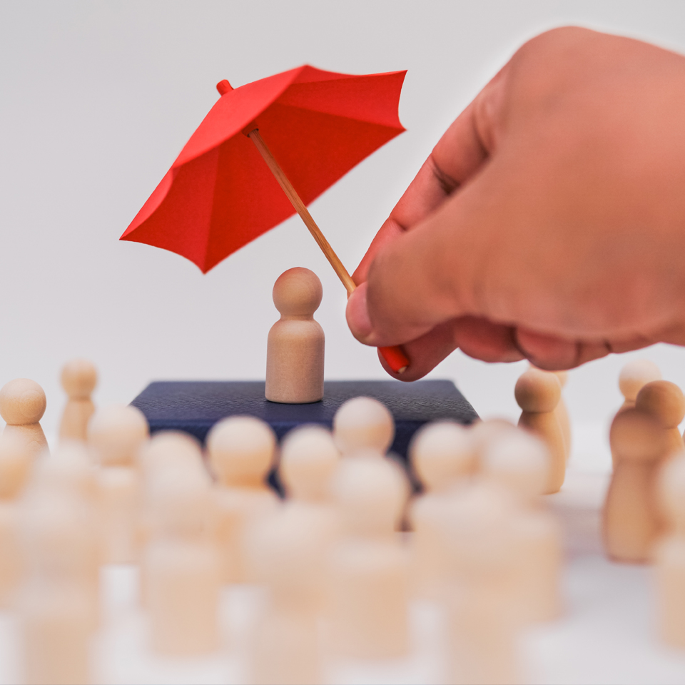 A man holding a umbrella protects the leader and their team