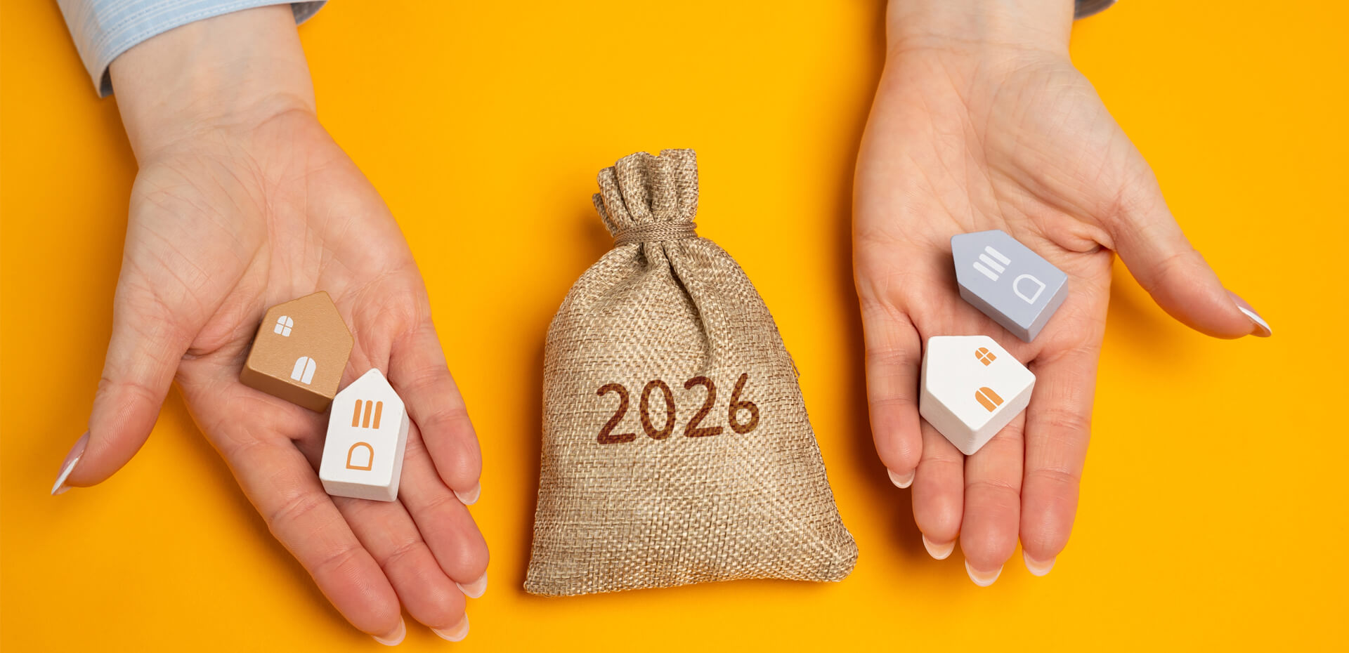 Image Showing hands holding houses made of woods