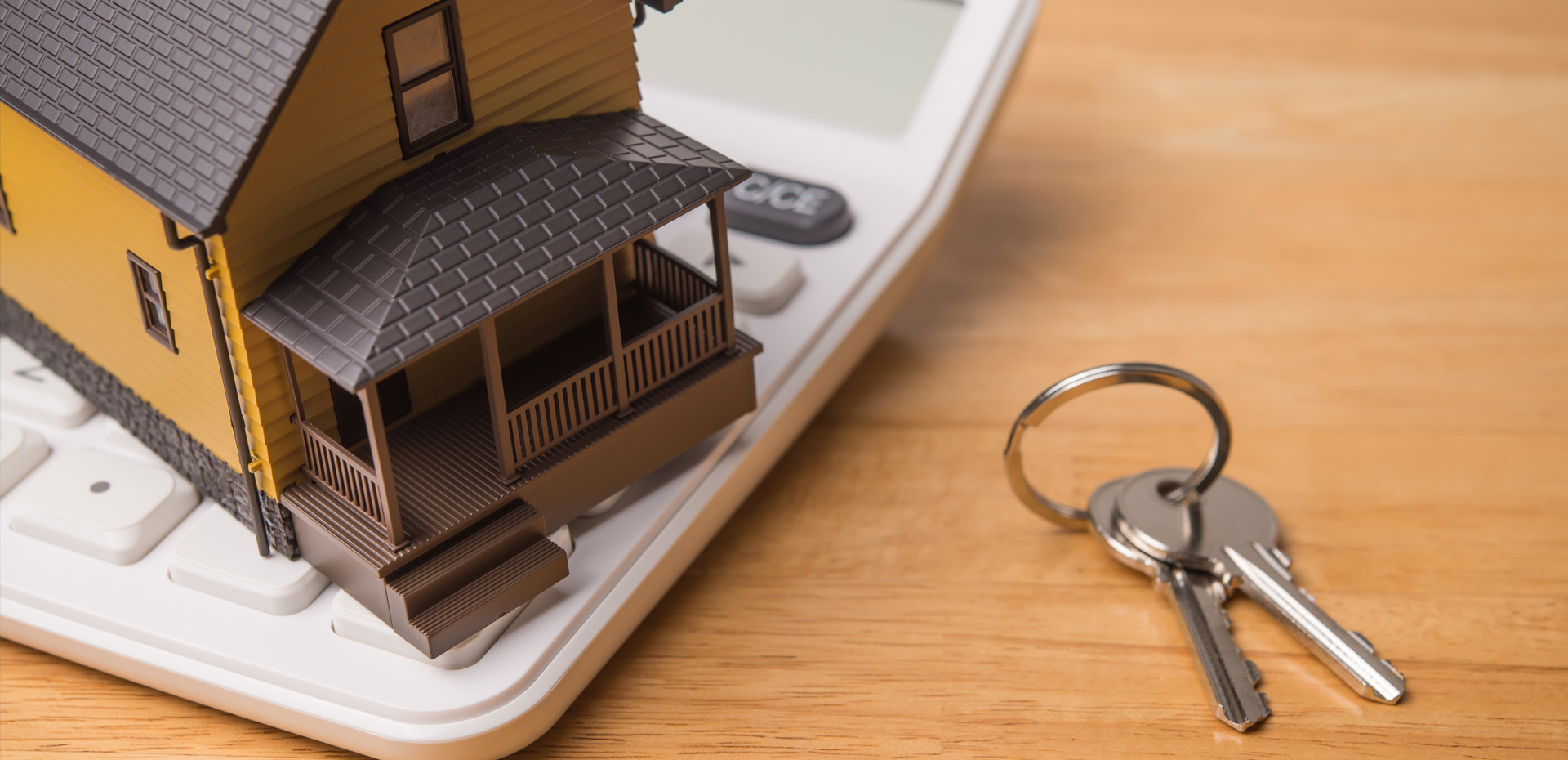 image showing a plastic house documents and keys on a desk