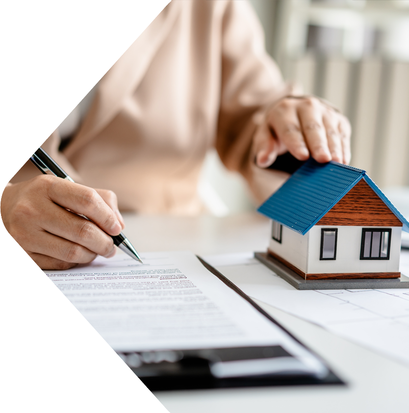 image showing a lady signing documents and a small house