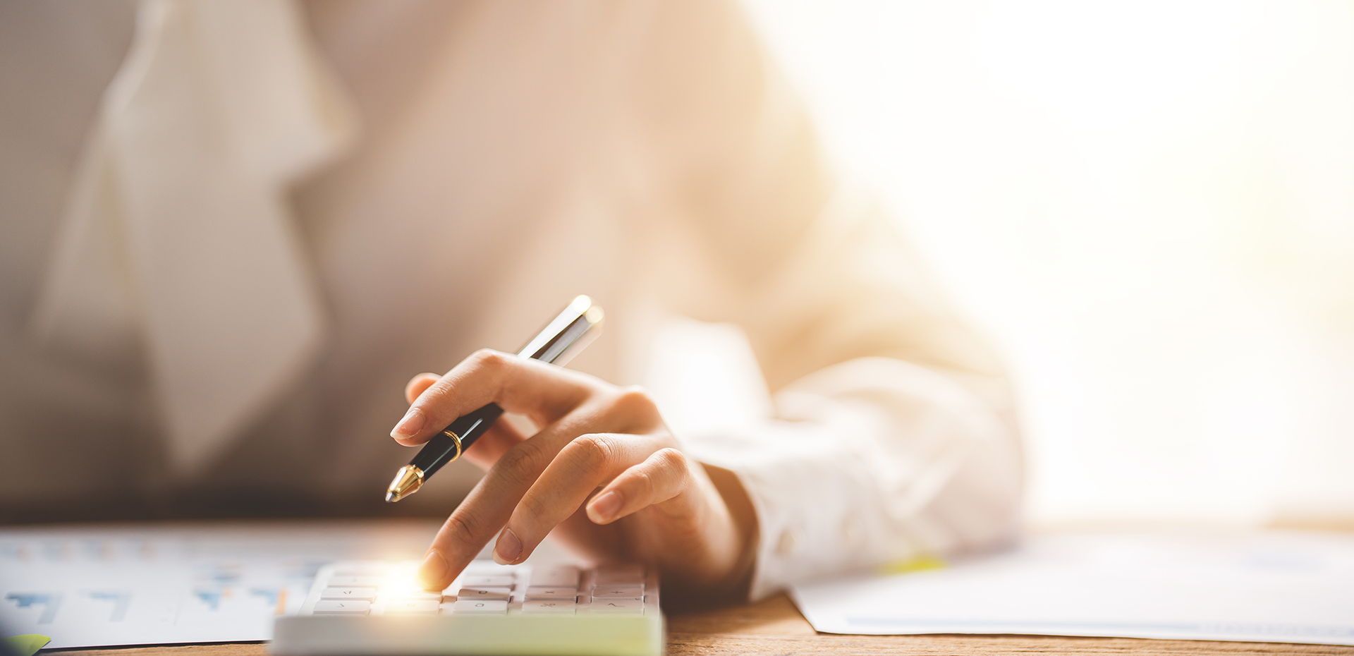 Image showing a close up of a woman using a calculator